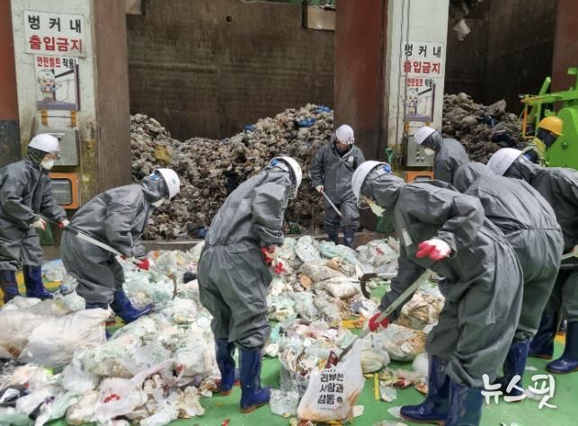 자원회수시설에서 소각용 생활폐기물을 샘플링하고 있다.