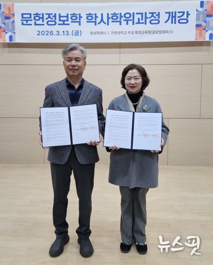 윤미영 도서관정책과장과 가천대 평생교육원 이재원 주임교수가 협약서를 들고 기념촬영을 하고 있다.(화성시 제공)